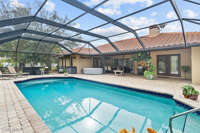 view of pool featuring a patio area, a hot tub, french doors, and glass enclosure