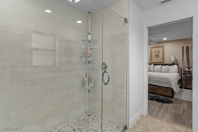 bathroom with ceiling fan, wood-type flooring, and an enclosed shower