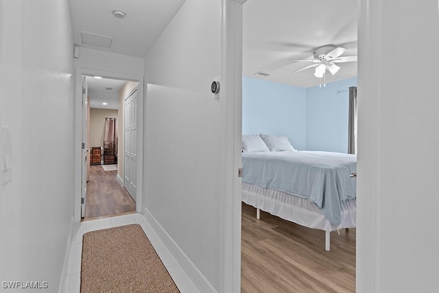 bedroom with ceiling fan and light hardwood / wood-style floors