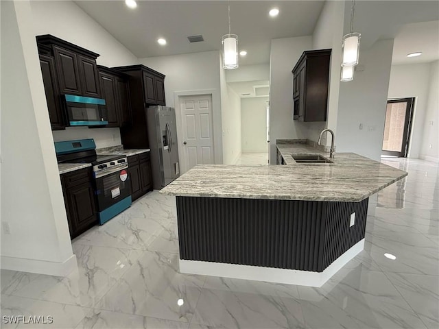 kitchen with appliances with stainless steel finishes, decorative light fixtures, kitchen peninsula, and sink