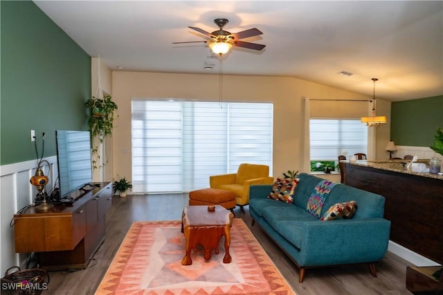 4176 Madison St, Ave Maria, FL 34142 - living room featuring ceiling fan, wood finished floors, lofted ceiling, a wainscoted wall, and a chandelier