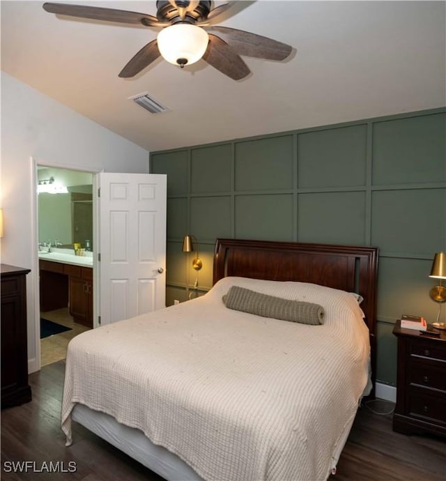 4176 Madison St, Ave Maria, FL 34142 - bedroom featuring a decorative wall, dark wood-style flooring, vaulted ceiling, connected bathroom, and ceiling fan