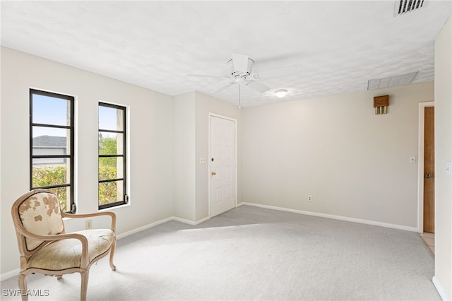 unfurnished room with light carpet and ceiling fan