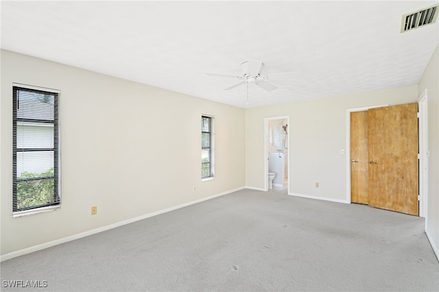 carpeted spare room with ceiling fan