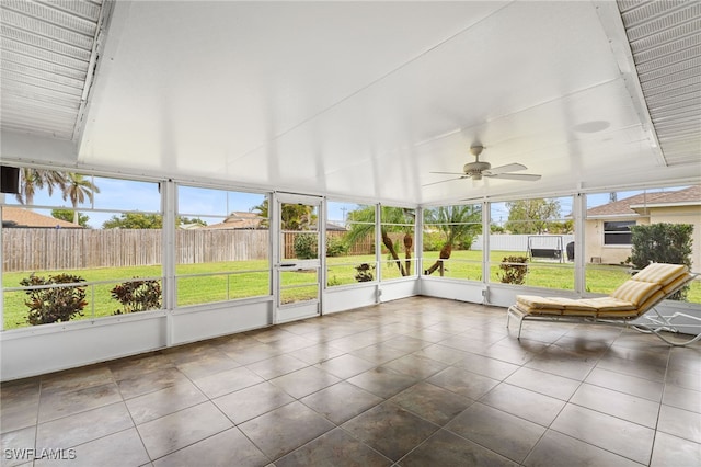 unfurnished sunroom featuring ceiling fan