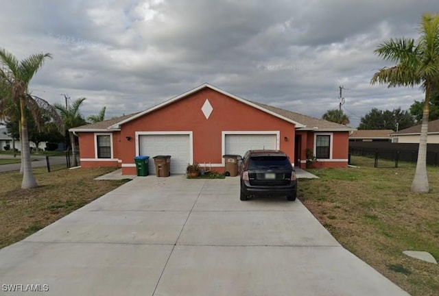 ranch-style home with a garage and a front yard