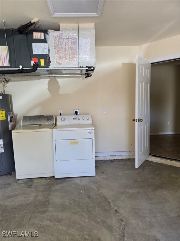 clothes washing area featuring washing machine and dryer and water heater