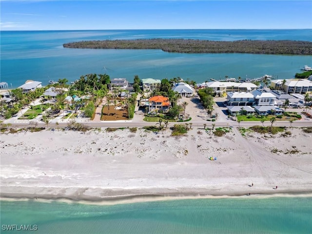 drone / aerial view featuring a water view and a view of the beach