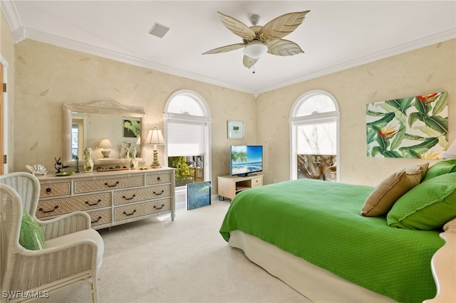 carpeted bedroom featuring crown molding and ceiling fan