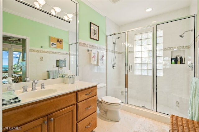 bathroom with a shower with shower door, tile patterned flooring, vanity, toilet, and crown molding