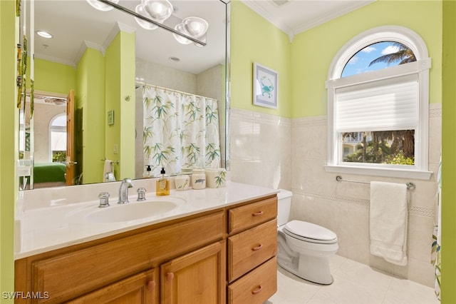 bathroom with tile walls, tile patterned flooring, ornamental molding, vanity, and toilet