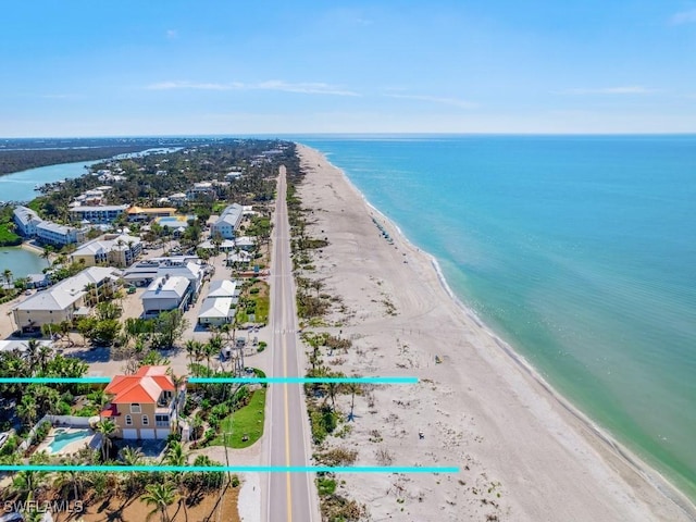 bird's eye view featuring a water view and a beach view