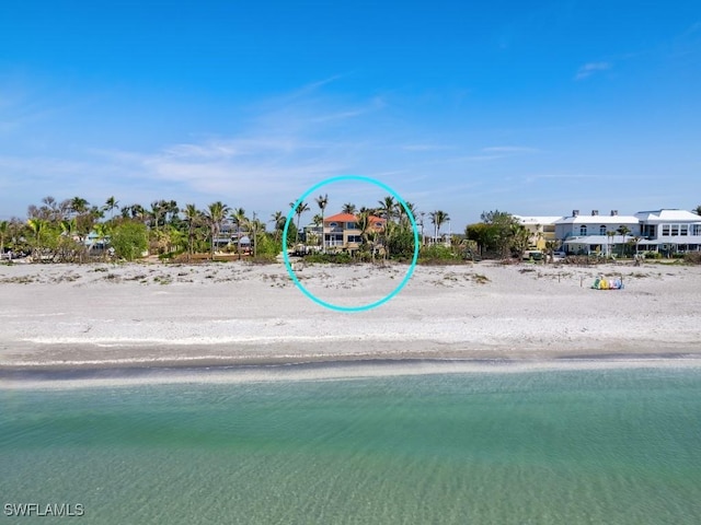 view of property's community with a water view and a view of the beach