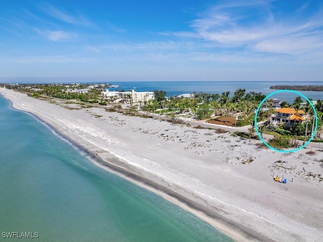 drone / aerial view featuring a water view and a beach view