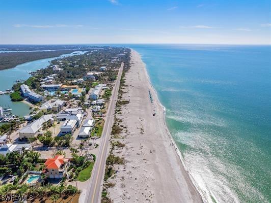 aerial view featuring a water view and a view of the beach