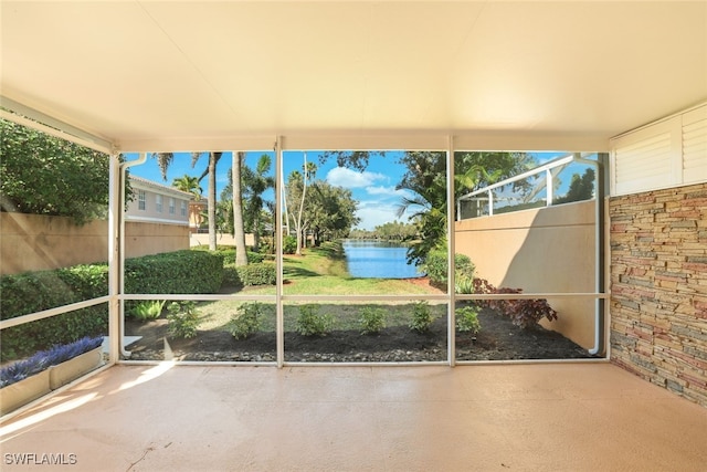 unfurnished sunroom featuring a water view