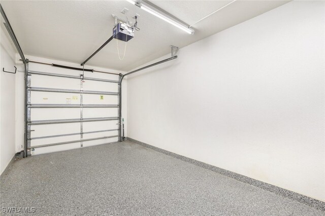 garage with a garage door opener and baseboards