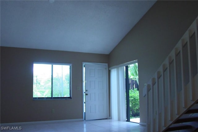 entrance foyer featuring vaulted ceiling and tile patterned floors