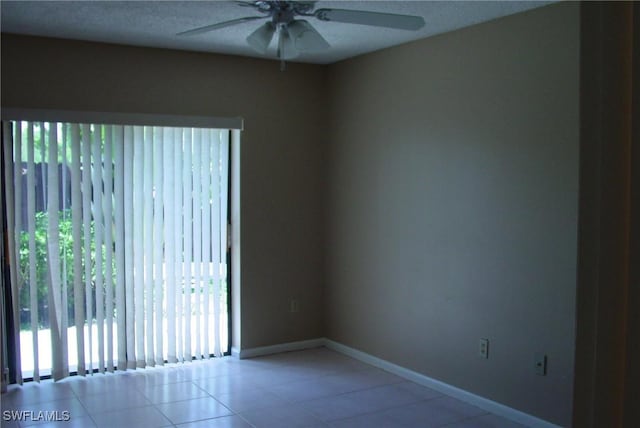 tiled empty room with ceiling fan