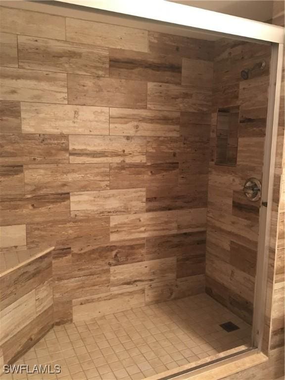 bathroom with tiled shower