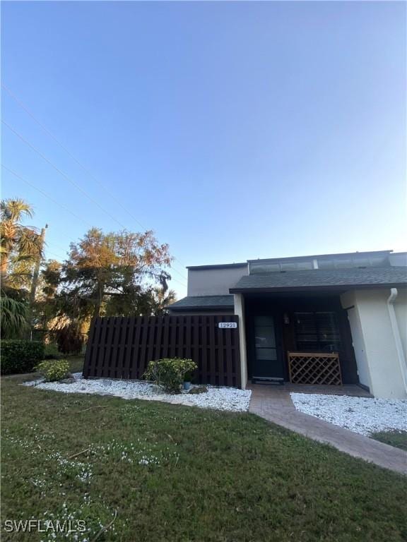 view of side of property featuring a yard