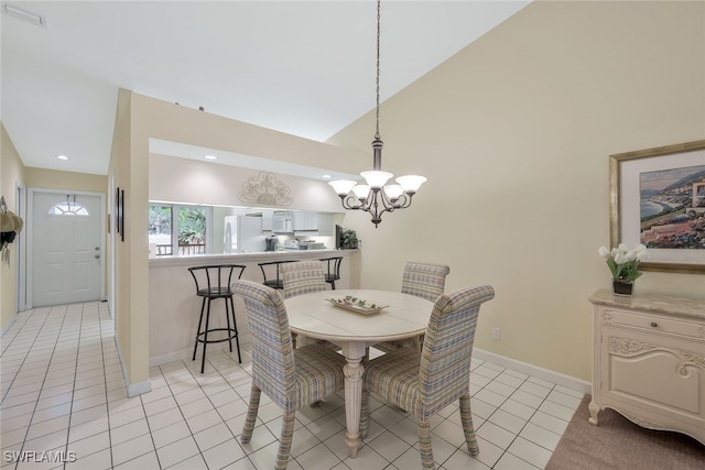 tiled dining area featuring a notable chandelier and high vaulted ceiling