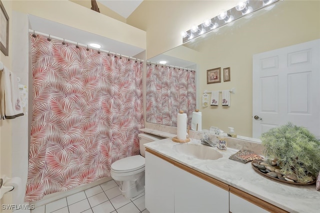 bathroom with tile patterned flooring, vanity, and toilet