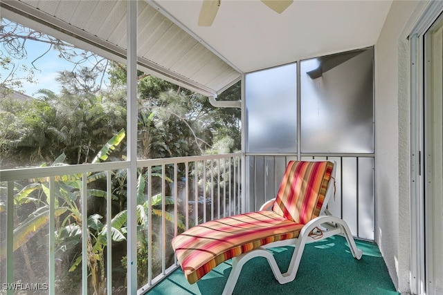 unfurnished sunroom with ceiling fan