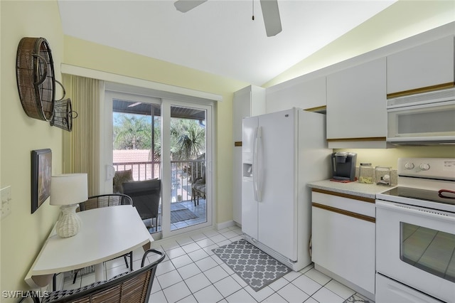 kitchen featuring lofted ceiling, white appliances, white cabinets, and light tile patterned flooring