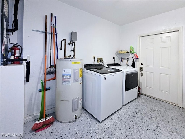 washroom with washer and dryer and water heater