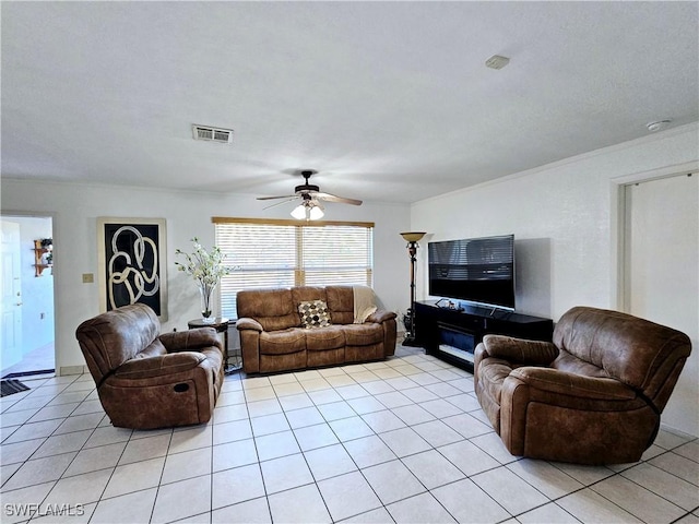 tiled living room with crown molding and ceiling fan