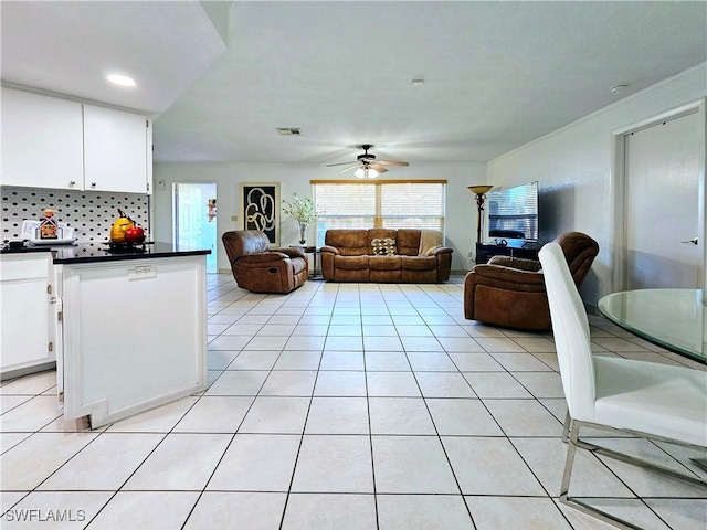 living room featuring light tile patterned floors and ceiling fan