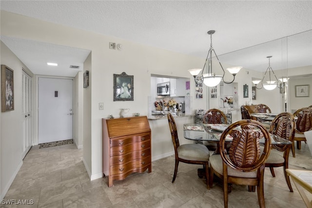 dining room with a textured ceiling