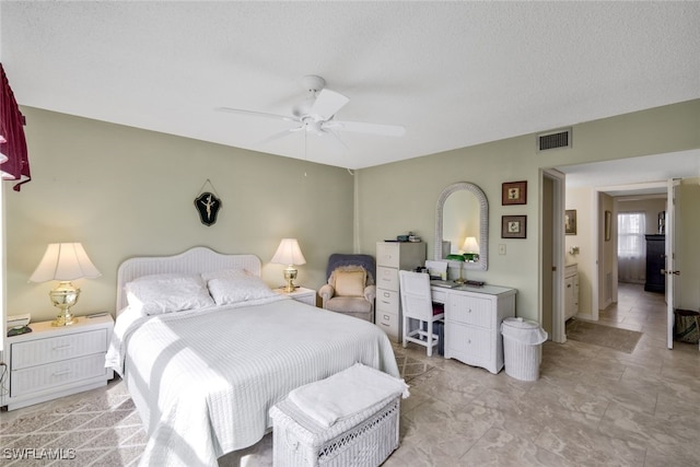 bedroom with ceiling fan and a textured ceiling