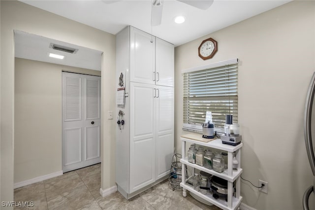 interior space featuring white cabinetry and ceiling fan