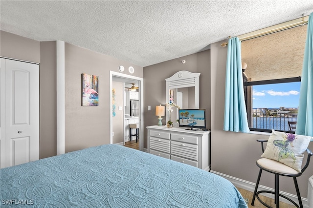 bedroom featuring wood-type flooring and a textured ceiling