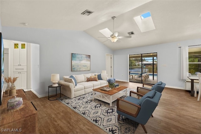 living room with lofted ceiling with skylight, hardwood / wood-style floors, and ceiling fan