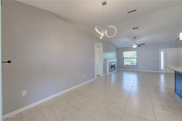 unfurnished living room featuring lofted ceiling, ceiling fan, and light tile patterned flooring