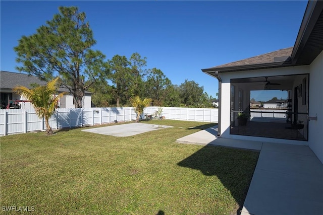 view of yard with ceiling fan and a patio area