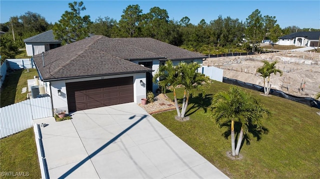 view of front facade with a garage and a front lawn