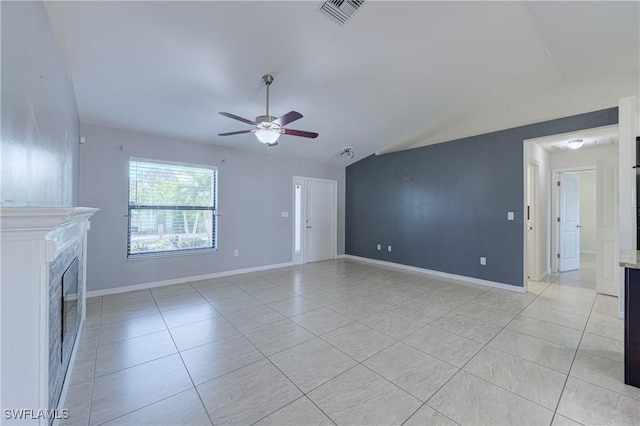 unfurnished living room featuring vaulted ceiling, light tile patterned floors, and ceiling fan