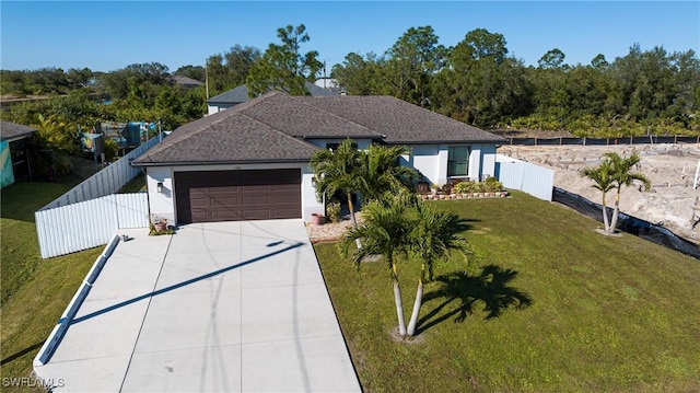 view of front of house with a garage and a front lawn