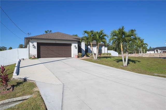 ranch-style house with a garage and a front lawn