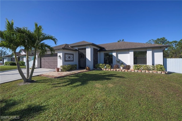 view of front of home with a garage and a front lawn