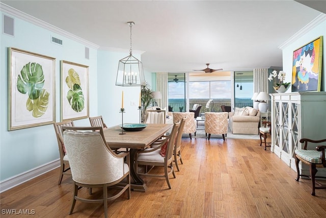 dining area with crown molding, floor to ceiling windows, ceiling fan, and light wood-type flooring