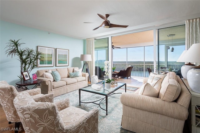 living room featuring wood finished floors, a ceiling fan, crown molding, and a wall of windows