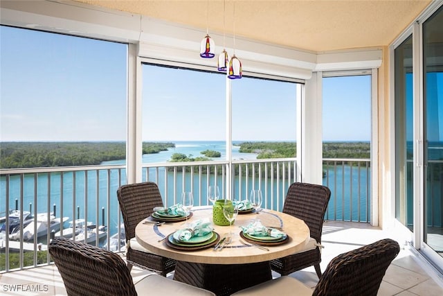 sunroom / solarium featuring a water view