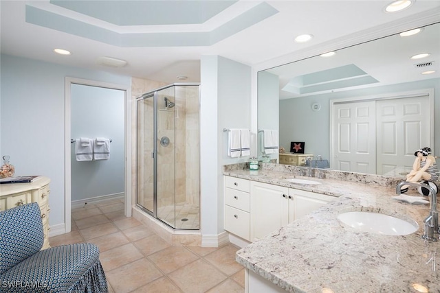 bathroom featuring an enclosed shower, vanity, tile patterned floors, and a raised ceiling