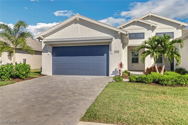 view of front of home featuring a garage and a front lawn