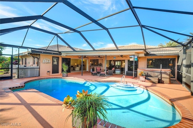 view of pool featuring ceiling fan, a hot tub, a patio, and a lanai